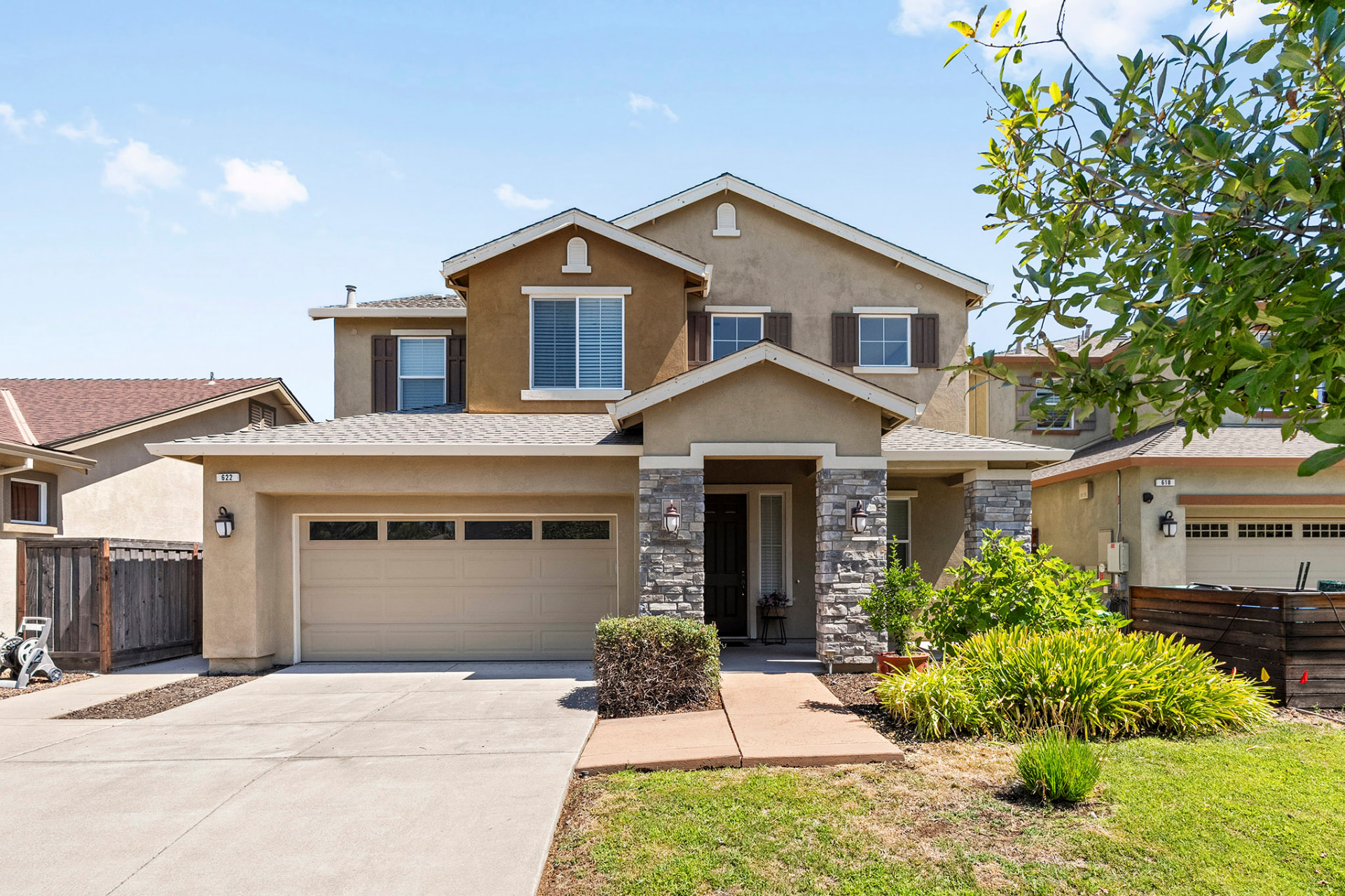 Front exterior of 622 Brush Creek Lane with stone accents and a two-car garage